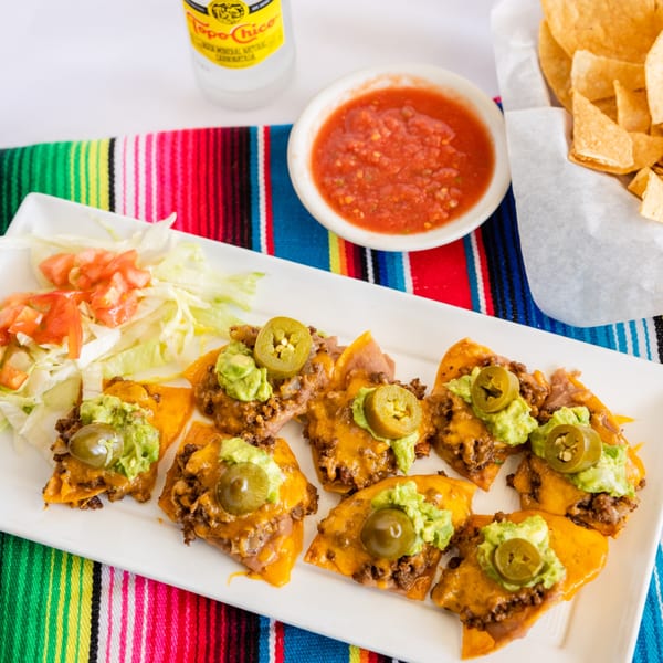 Town House Restaurant's nachos with ground beef, cheese, guacamole, and jalapeños, served with salsa and chips.